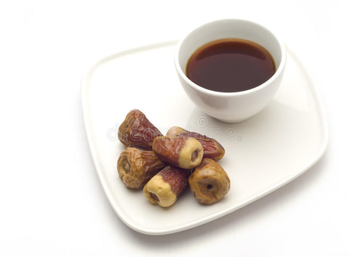 A coffee cup and dates