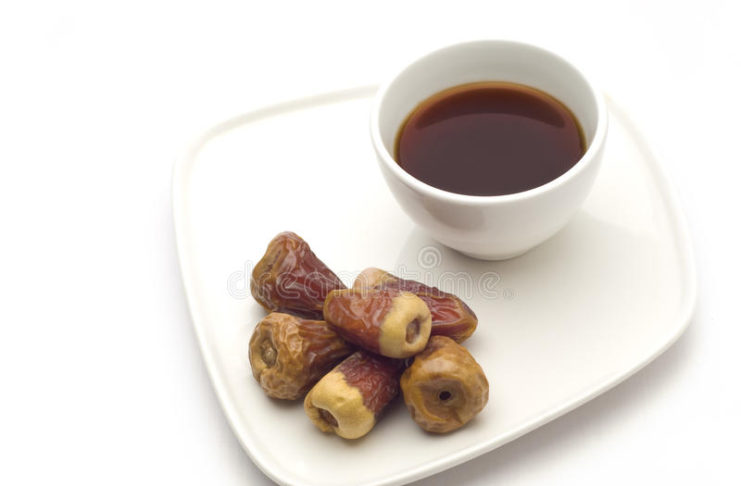 A coffee cup and dates
