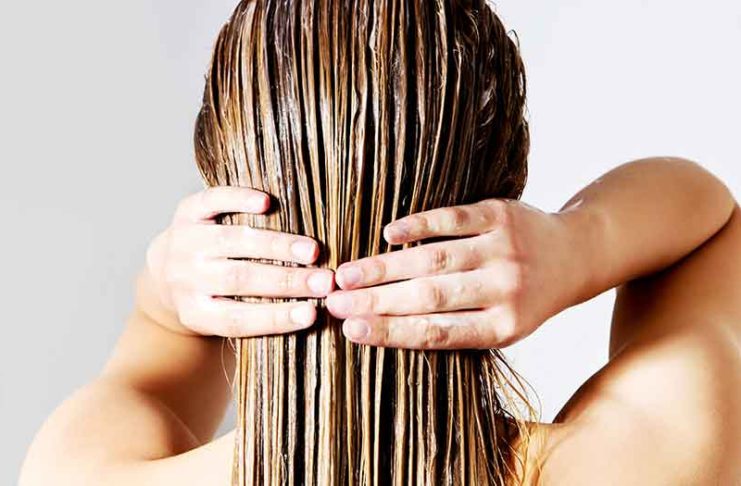 A girl applying a coffee hair mask