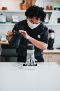 a barista pouring hot water