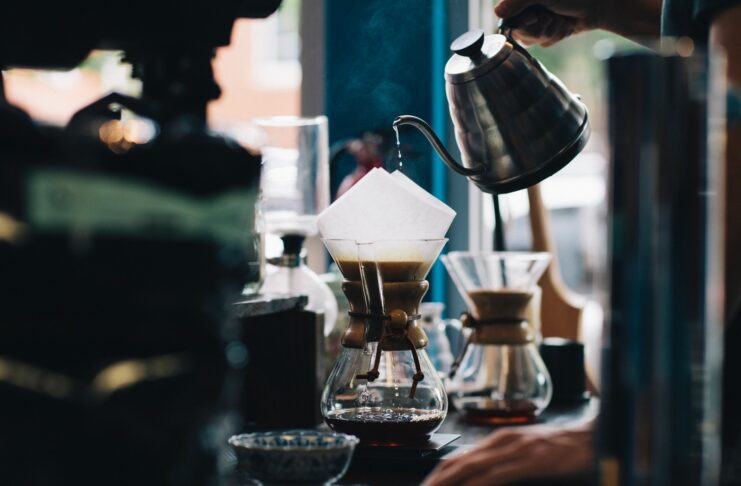 a person pouring hot brew coffee