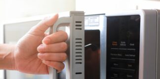 a woman opening a microwave