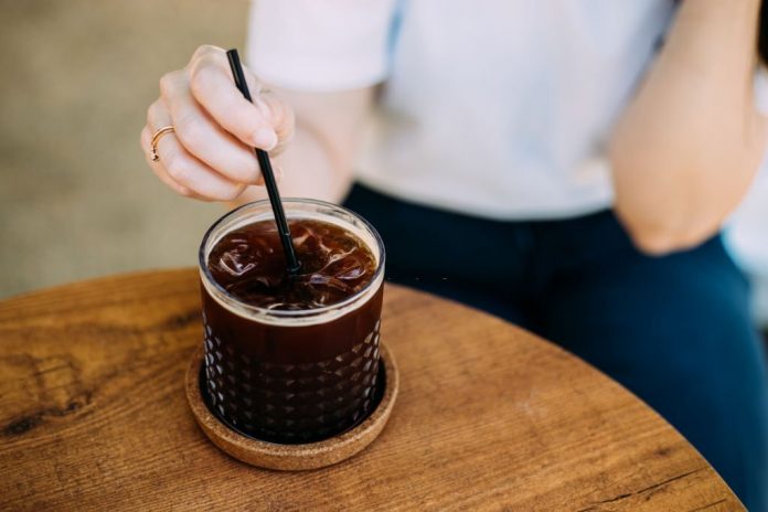 A glass of iced americano on the table